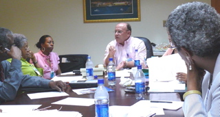 Chairman Carmelo Rivera, center, makes a point to the Juan F. Luis Hospital board.