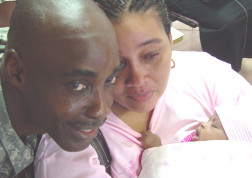 First Sgt. Dale Carty and his wife, Bebe, who holds their month-old granddaughter, Li'niaya Cantois.