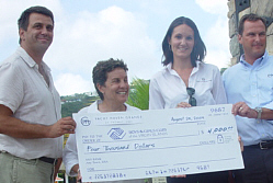 Peter Zachko (left to right) and Julie Landreneau of the Boys and Girls Club of the Virgin Islands accept a big check from Yacht Haven Grande's Josalyn Bitterman and Chris Petty.