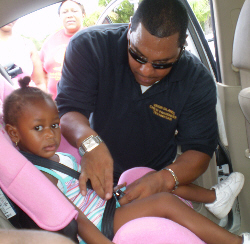 V.I. Police Officer Juan Concepcion gets Leonisha Bazil buckled in.