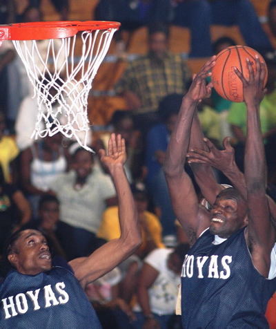 Hoyas’ Akeem 'Mountain' Francis, right, goes high for a rebound.
