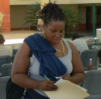 Volunteer Felicia Lloyd hands out information at the rally.