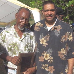 Charlie 'Sweetman Bordeaux' Leonard is congratulated by Gov. John deJongh Jr.