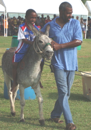 Trey McKenzie, 7, and his father Keith circumnavigate the course in the Donkey Derby.