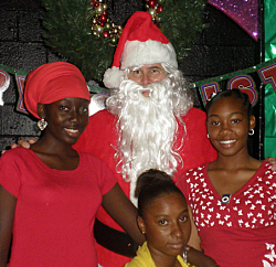 Santa with elves Anesha Corbett (left to right), Mikesha LeBron and Angela Lettsome.