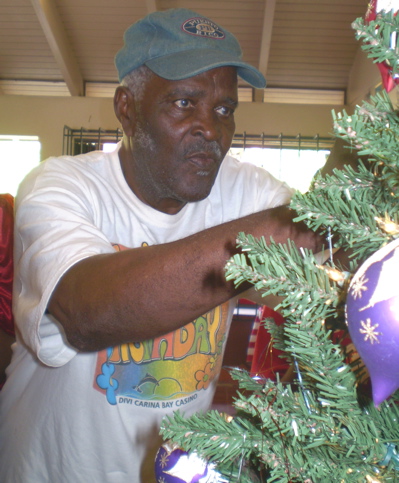 Charles Seth decorates the tree at the annual Delta Sigma Theta Christmas party.