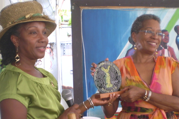 Sandra Setorie, left, president of BPW, presents Delegate Donna M. Christensen with a plaque featuring the BPW emblem.
