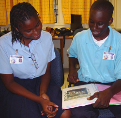 Cherisma Callwood (left) and T.J. Thompson review his finance class notebook.