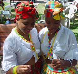 Caribbean Ritual Dancers Kaiisa Pinney and Chantell Bernier admire the new V.I. quarter.