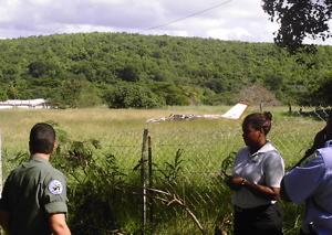 The wreckage of a Cessna 177 sits in a field off East Airport Road, where it crashed Thursday.