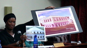 Debra Benjamin, project director for the St. Croix Women's Coalition's Fisher Street Community Crisis Center, showing a photo of the group's headquarters under construction along with an artist's conception of the finished building