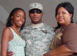 Sgt. Llewellyn Edinborough saying goodbye August 12 to his sister and mother before deploying to Camp Atterbury. The unit is now ready to deploy to Kosovo.