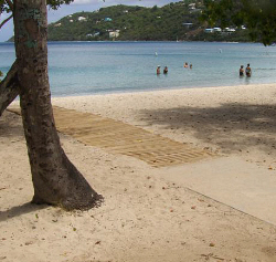 A wheelchair path of cement and wooden planks leads to the water at Magens Bay.