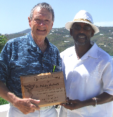 Dr. Malcolm MacDonald (left) receives an award from Dr. Marlon Williams of the V.I. Chiropractic Society.