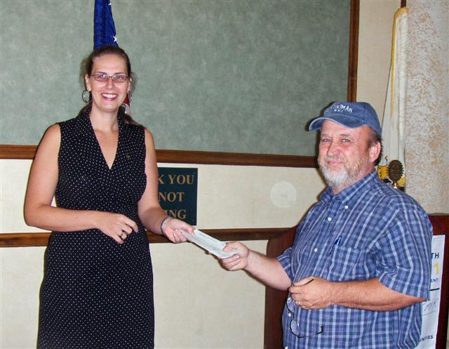 Rotary Club of St. Thomas Sunrise president Kathrynne Green presents check to Scott Bradley of My Brother’s Workshop.