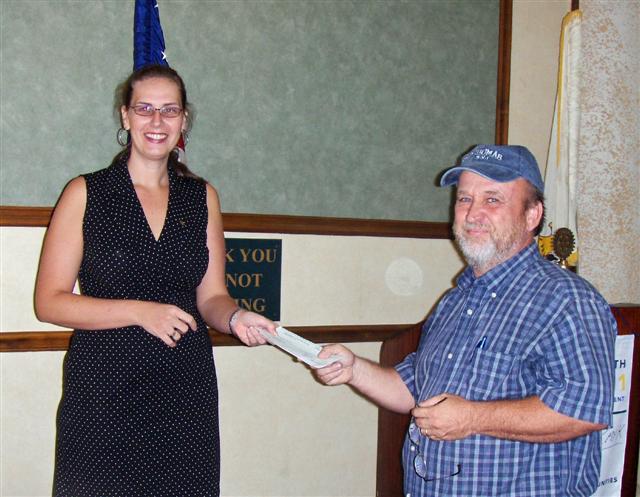 Rotary Club of St. Thomas Sunrise president Kathrynne Green presents check to Scott Bradley of My Brother&rsquo;s Workshop.