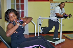 Sonia Moore-Williams, left, and Kaydee Viveros demonstrate techniques on the Curves resistance machines.