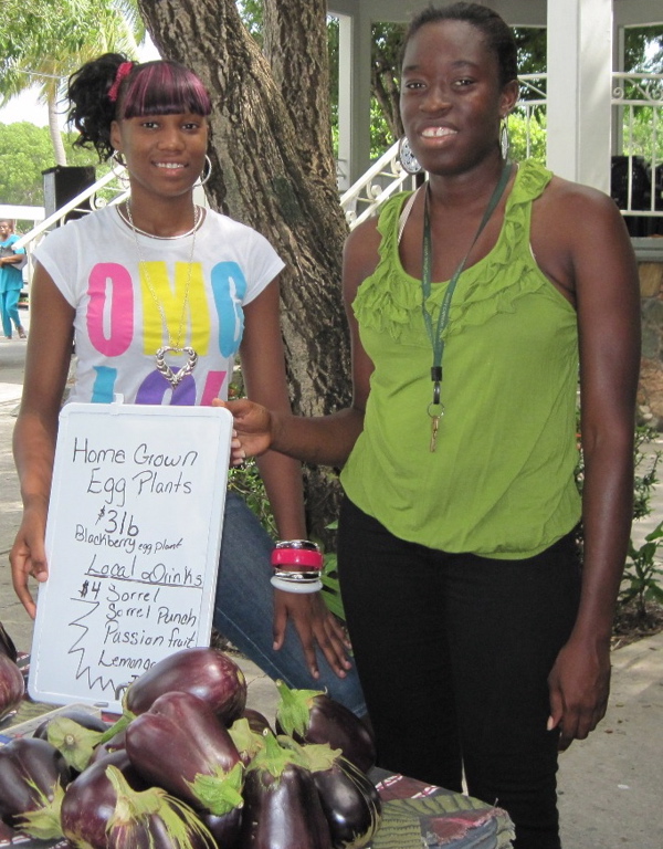 Shannika Isidore, left, and Kishma Riley sell eggplant.