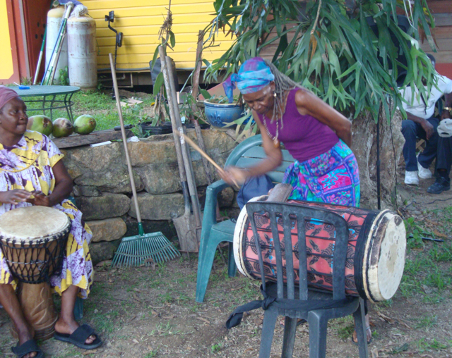 Joyce Francis, a member of the drum group Asche Akoma, plays the jun jun as part of the annual Jumbie Talk activities.