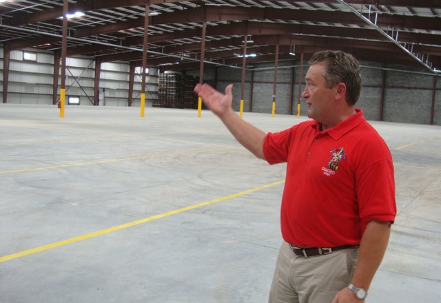 Diageo USVI Vice President Dan Kirby shows off one of the 100,000-square-foot warehouses completed Thursday.