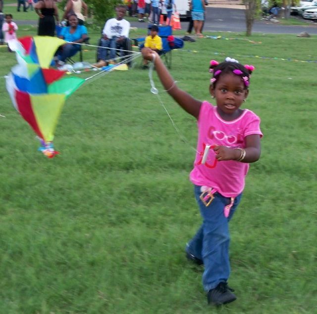 Dijamore Felix, 3, tries to get her kite airborne.
