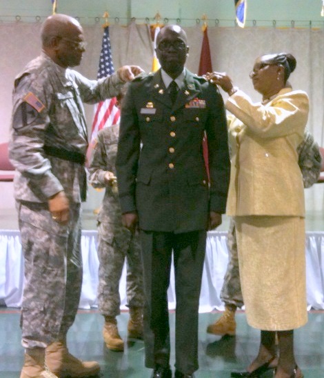 Maj. Gen. Renaldo Rivera (left) and Sutton's wife, Lorna, place the new oak leaf insignia on brand new Maj. Clayton A. Sutton.