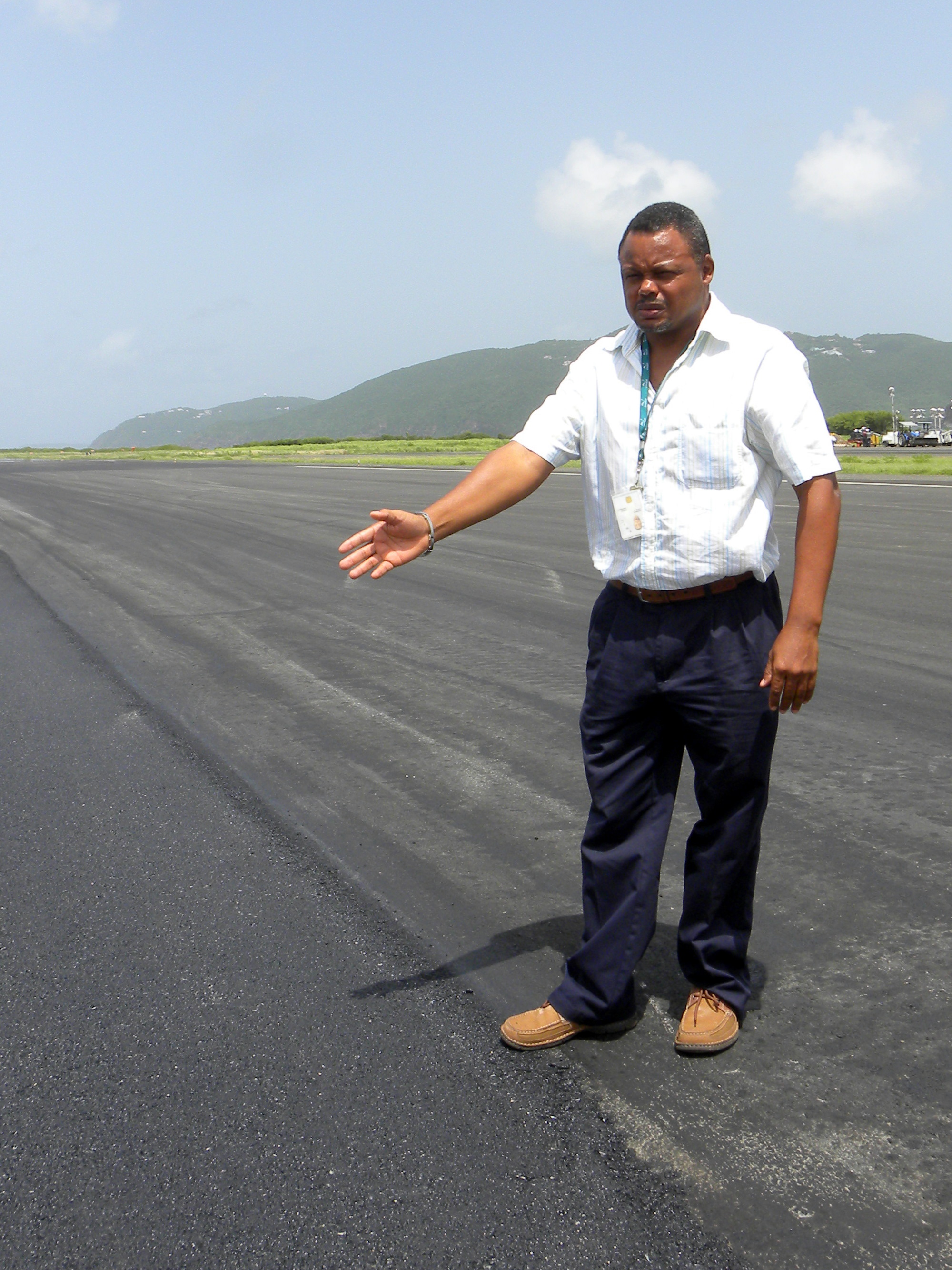 VIPA's Cecil V. Thomas stands next to a section paved Wednesday night.  