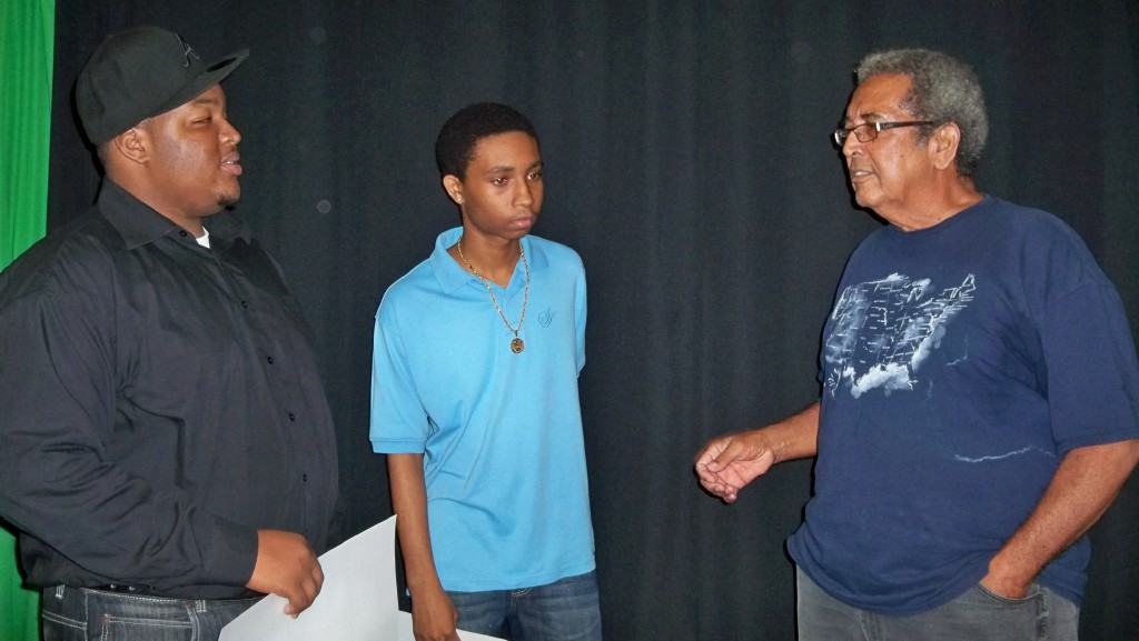 Scholarship recipients Ernel Edmond and Wayne Hawley (from left) talk with Stanley Jacobs about V.I. music.