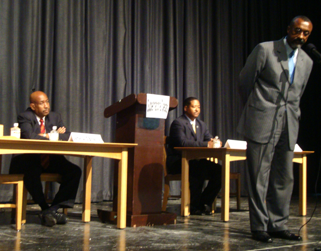Democratic gubernatorial candidates James O'Bryan (left) and Adlah Donastorg wait for their chance to speak as Gerard "Luz" James answers a question.