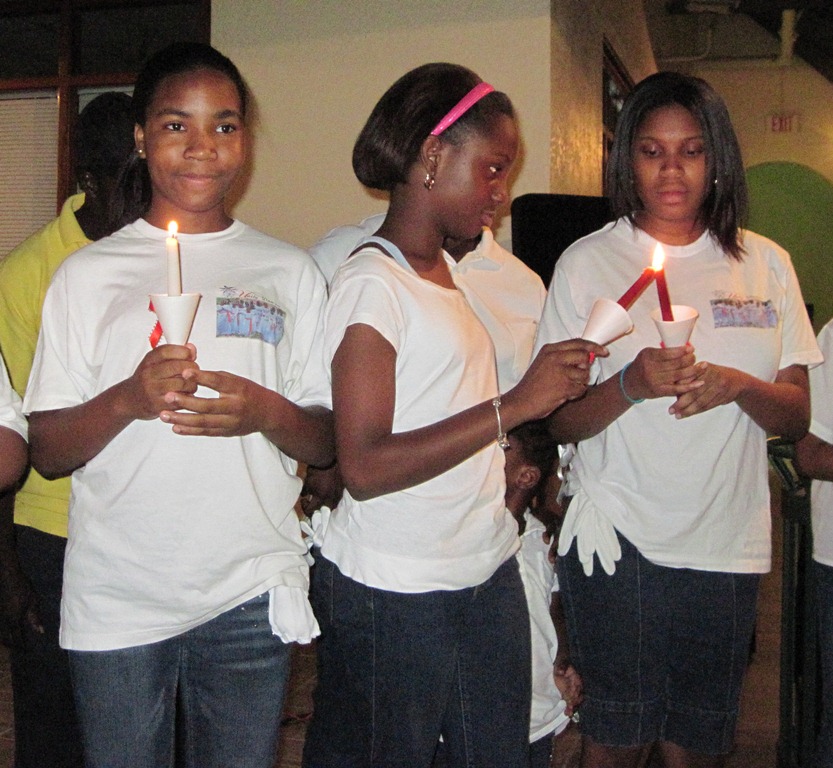 Candles being lit on St. John in remembrance of those who've died from HIV/AIDS.