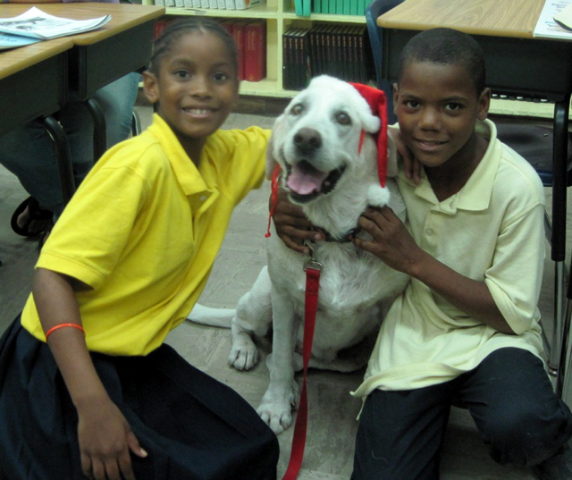 Magnolia helps teach Kiahra Boynes and Danny Perez how to care for dogs.