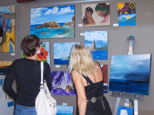 Fans look at paintings during the show of the Underwater 7.