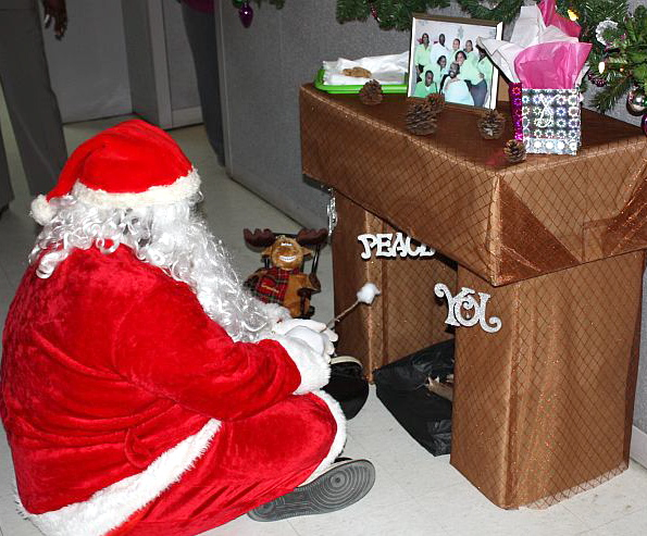 Santa Claus, in the person of David Dawson Jr., toasts a marshmallow as art of the holiday decor at the Department of Labor.