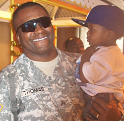 Sgt. Athneil Thomas (with his God son) was one of those soldiers happy to be home. (Photo courtesy Pfc. Janeel Gumbs)