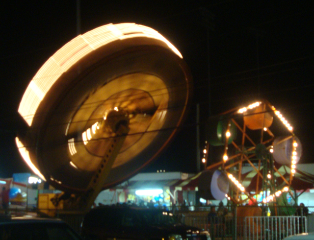 Carnival rides light up the Festival Grounds.