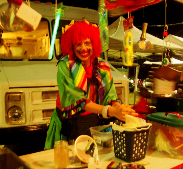 "Patsy the Clown" sets up her booth at the festival village.