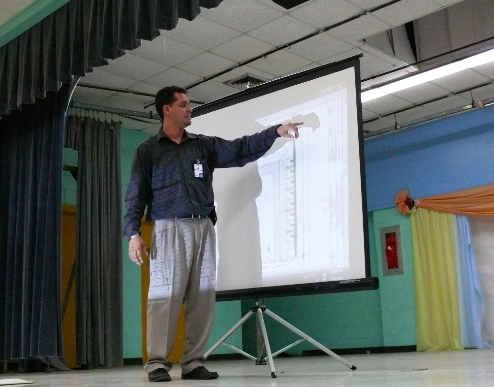 Deputy Commissioner of Public Works Roberto Cintron talking at Alfredo Andrews Elementary School Thursday evening about plans to renovate the La Reine Fish Market.