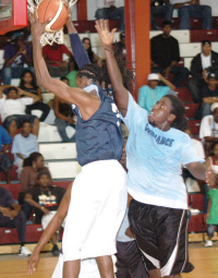 Kurt John of the Hoyas pulls down one of his team-high seven rebounds.