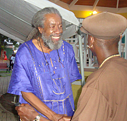 Mario Moorhead (left) is greeted by an audience member after his telling of the Emancipation Day story.