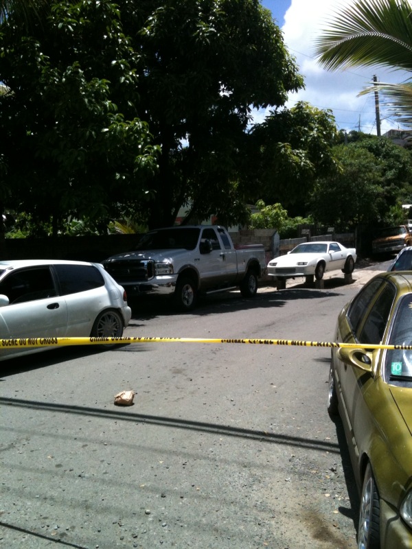 Police tape secures the crime scene in Estate Nadir after Monday's lunchtime shooting.