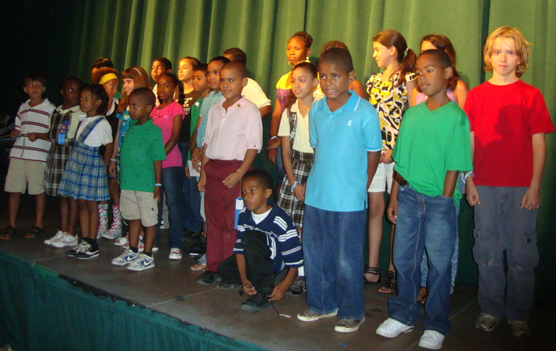 A crowd of young winning artists takes the stage at Caribbean Community Theater for the awards ceremony.