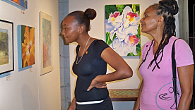 Hadiyah Shabazz (left) and Azizza Shabazz check out some of the artwork at Walsh Metal Works Gallery.