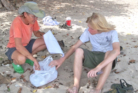 Carol Cramer-Burke gives Nathan Miller an SEA bandanna.