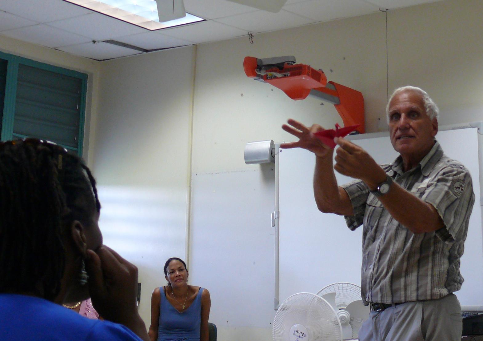 Retired St. Croix teacher Cy Levine demonstrates origami at the St. Croix MiniQuEST teacher development conference Monday.
