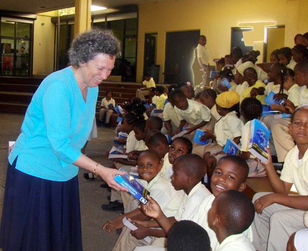 Gretta Moorhead distributes dictionaries to third graders.