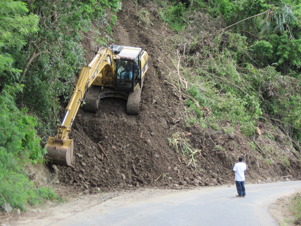 Crews on St. John Wednesday tend to the mudslide that runs from Upper Carolina to Centerline Road.