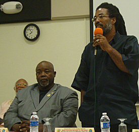 Senate candidate Wayne 'Bully' Petersen (left) listens as candidate Kendall Petersen speaks at Friday's forum.