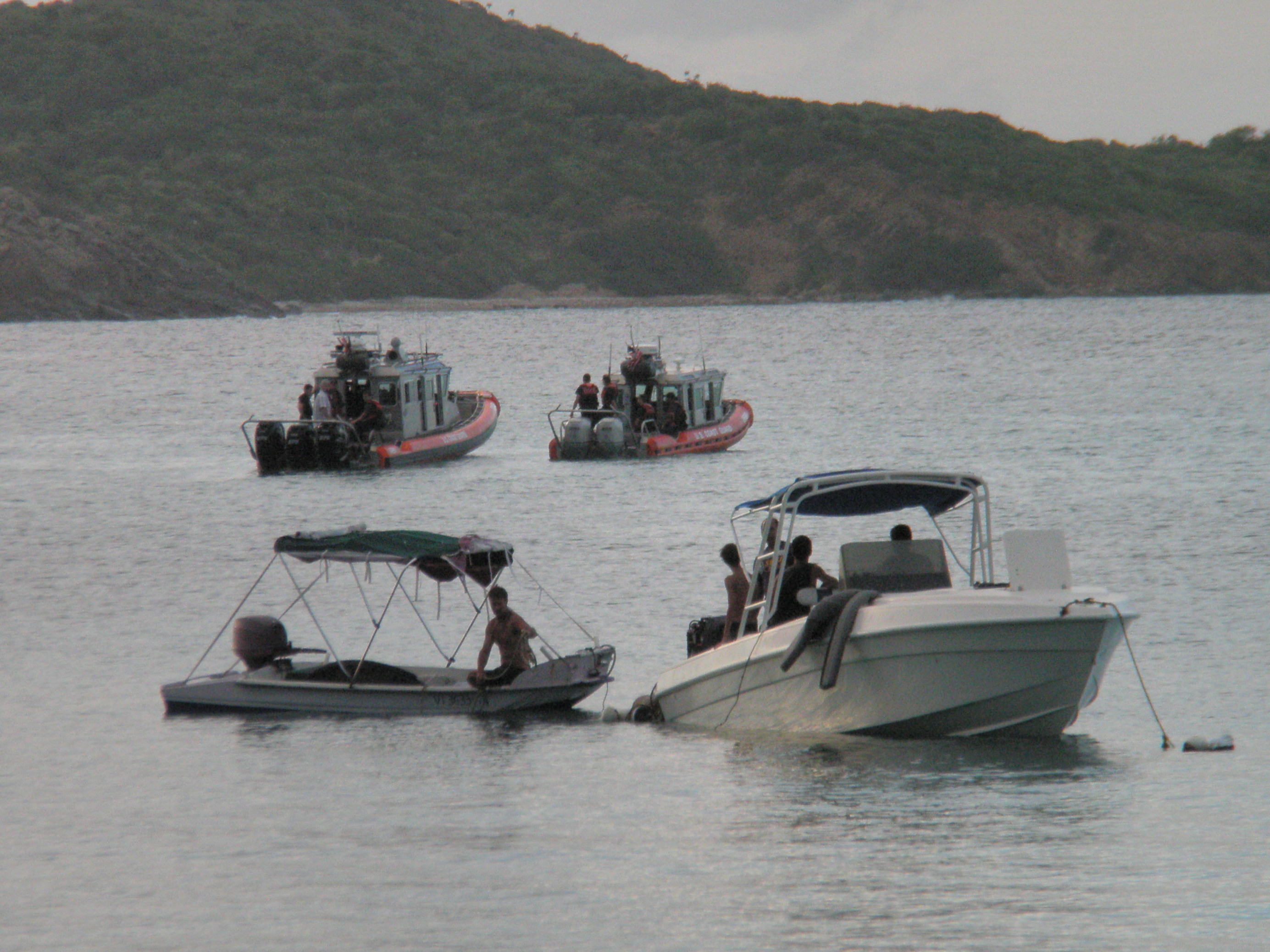 Pictured is the boat salvaged by North Side Fishermen, with interested Coast Guard in background.