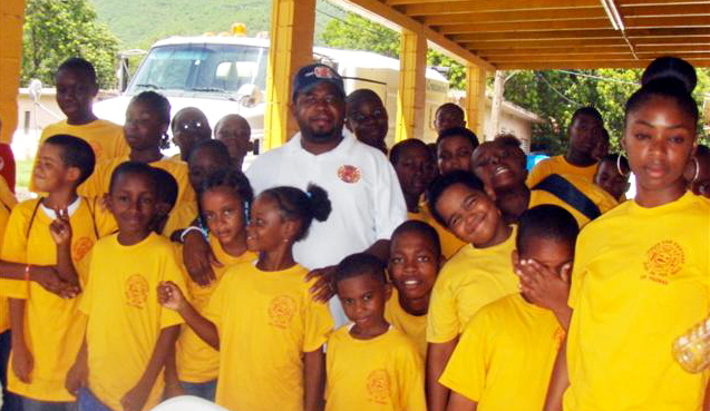 Director Daryl George, surrounded by Junior Firefighters   