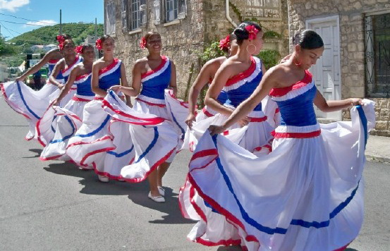 Members of Ballet Folklorio of Dominicana dance down King Street.